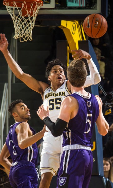 Brazdeikis leads No. 19 Michigan over Holy Cross 56-37